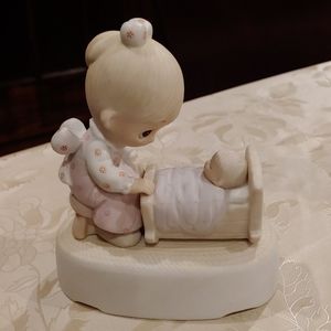 Precious Moment - the hand that rocks the future